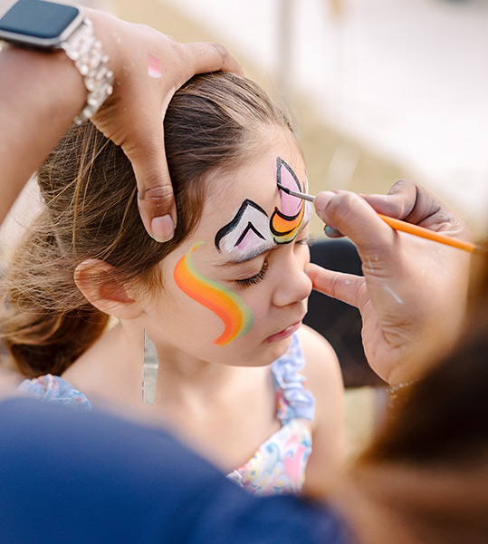 Little girl getting her face painted at 2024 Run Wild event