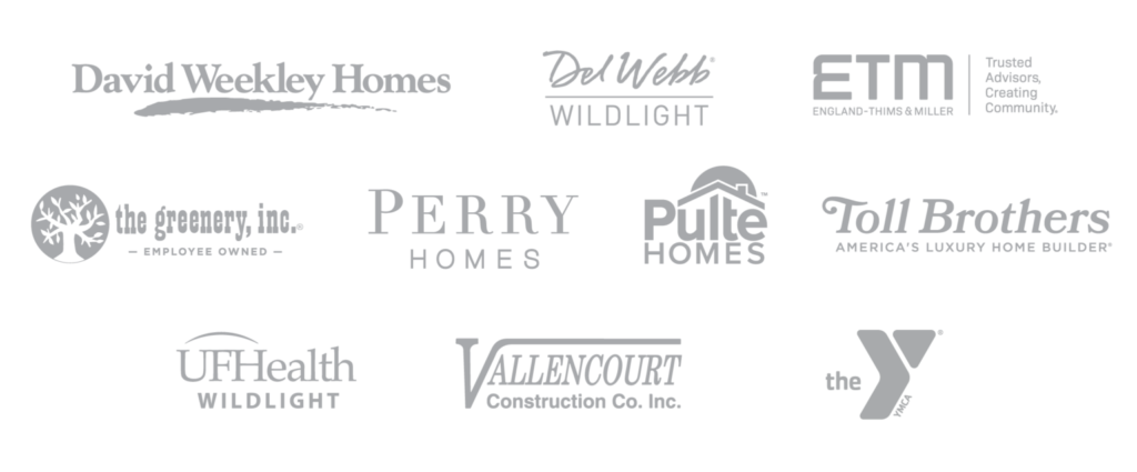 A collection of grayscale logos from companies including David Weekley Homes, Del Webb Wildlight, ETM, and the Y—key partners shaping the Wildlight master planned community—displayed in a grid layout.