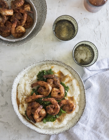 Aerial view of the Wildlight Yulee Florida community with homes in Nassau County Florida, central pool, clubhouse, green lawns, trees, and parked cars along the street.