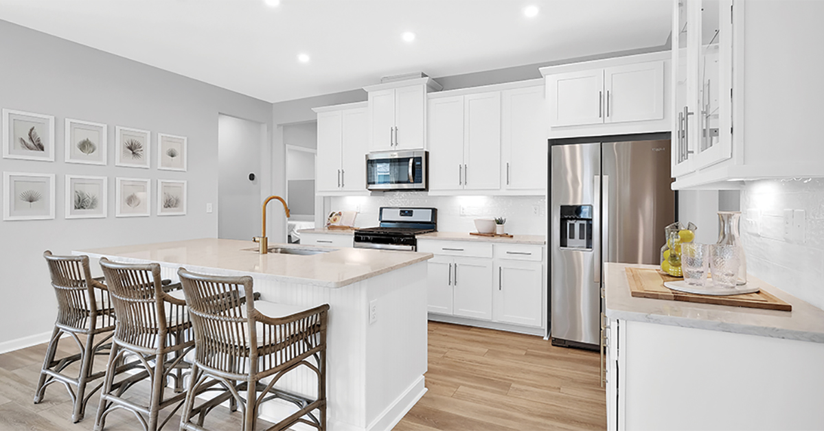 Mattamy Homes Wildlight open concept kitchen with floor to ceiling white cabinets and large island.