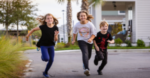 Wildlight, FL three kids running and playing in Founder's Park.