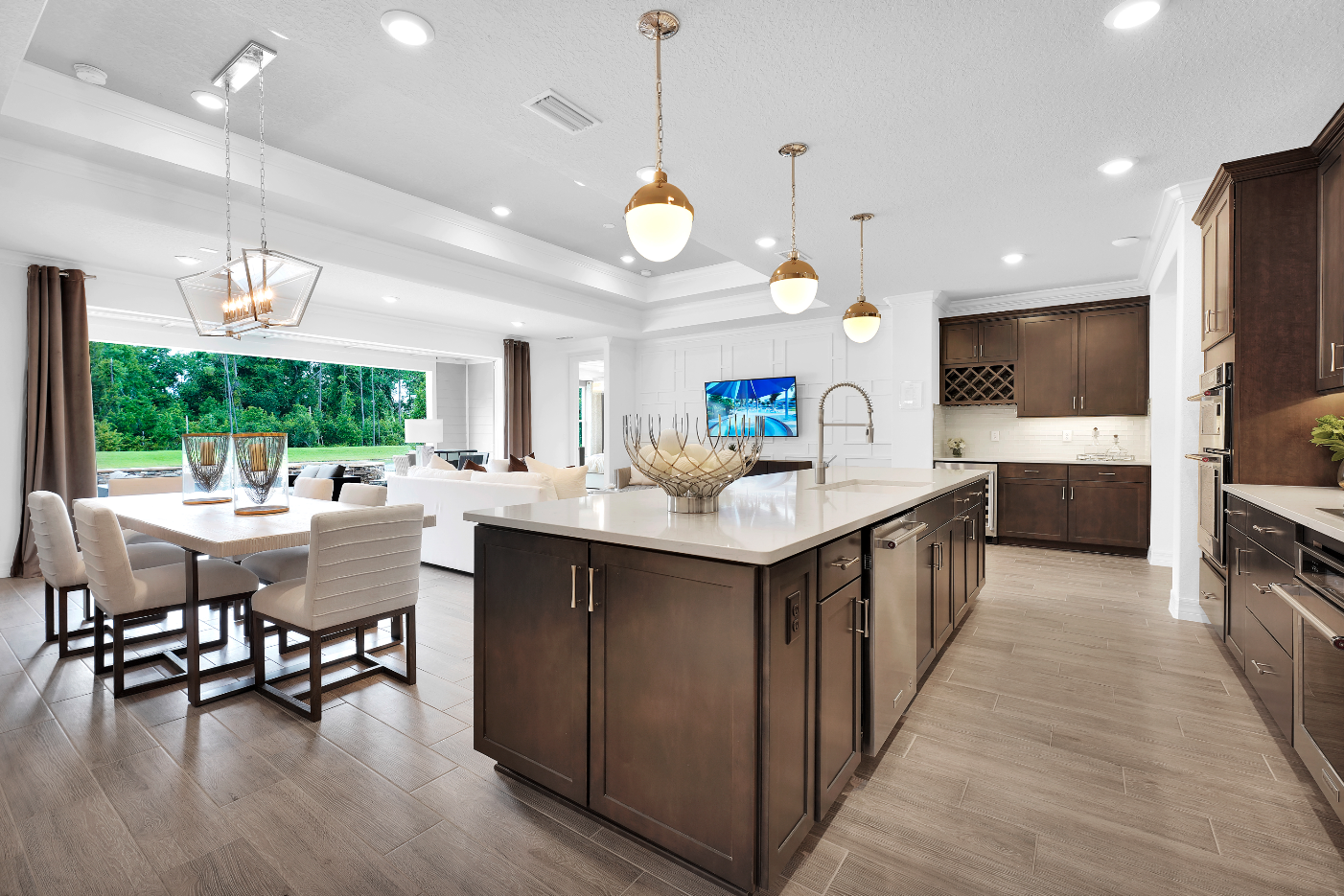 Del Webb Wildlight open concept kitchen, dining and living rooms with large island and big windows.