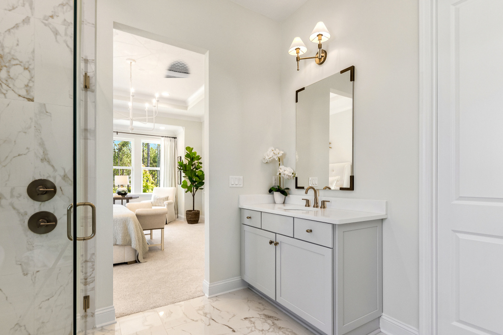 Riverside Homes Wildlight bathroom with large walk-in shower with black fixtures and single light gray vanity with white countertop.