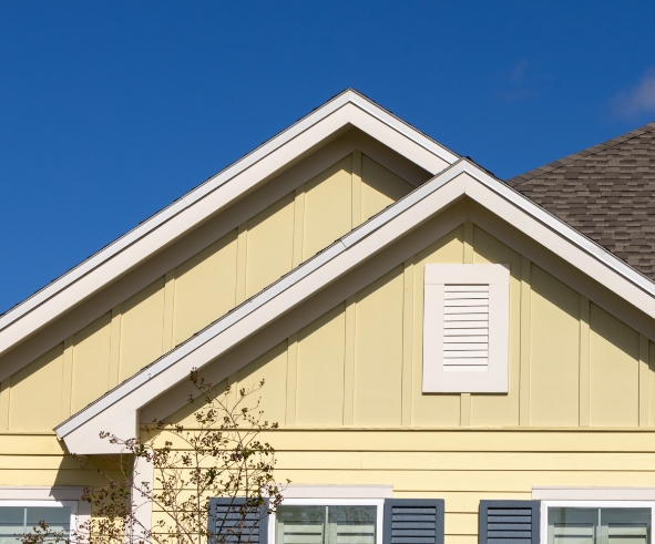 Double roofline of a yellow house in Wildlight.