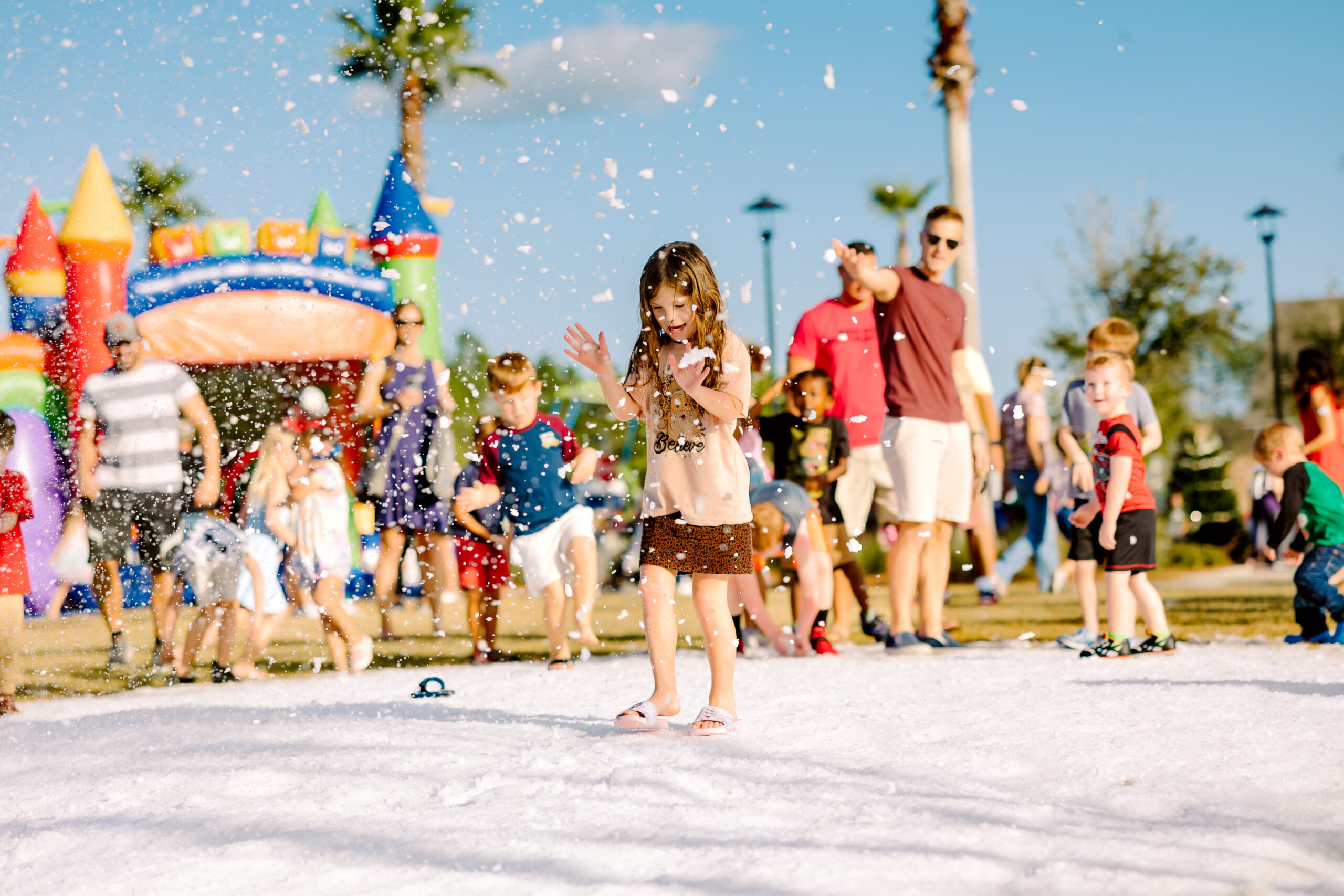 A group of children playing in the snow at Winterfest.