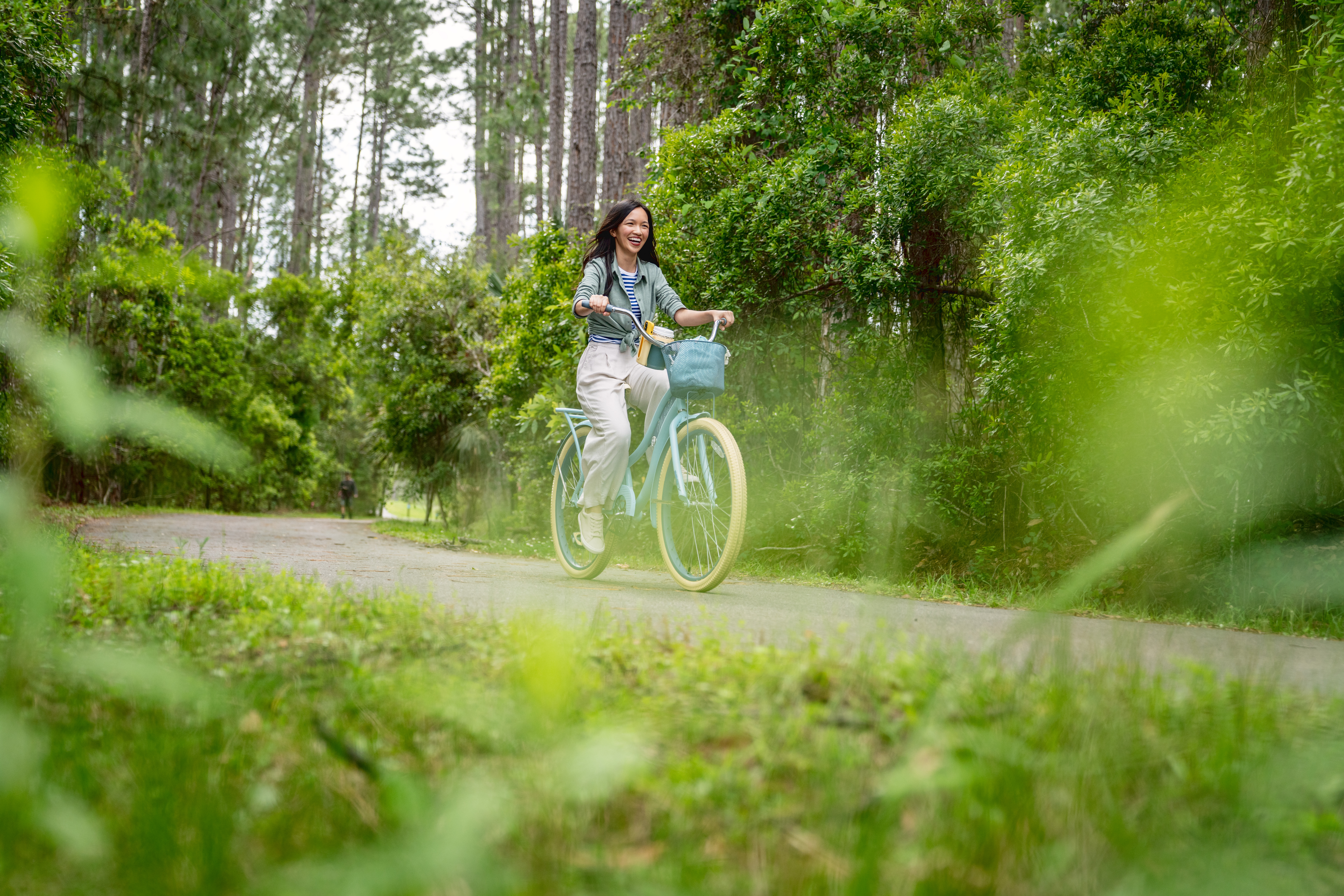 Girl riding blue cruiser bike on trail