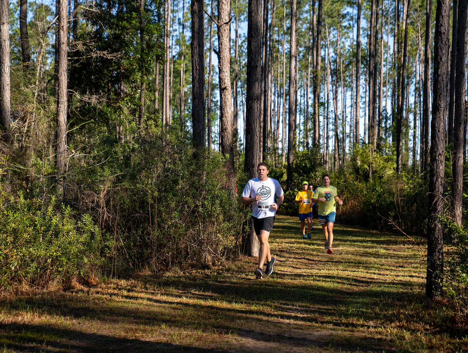 Run Wild 5K participants run down nature trail.