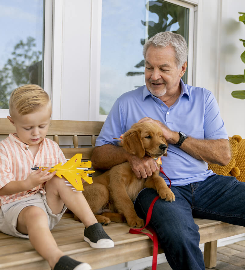 A man sitting on a bench with a dog.