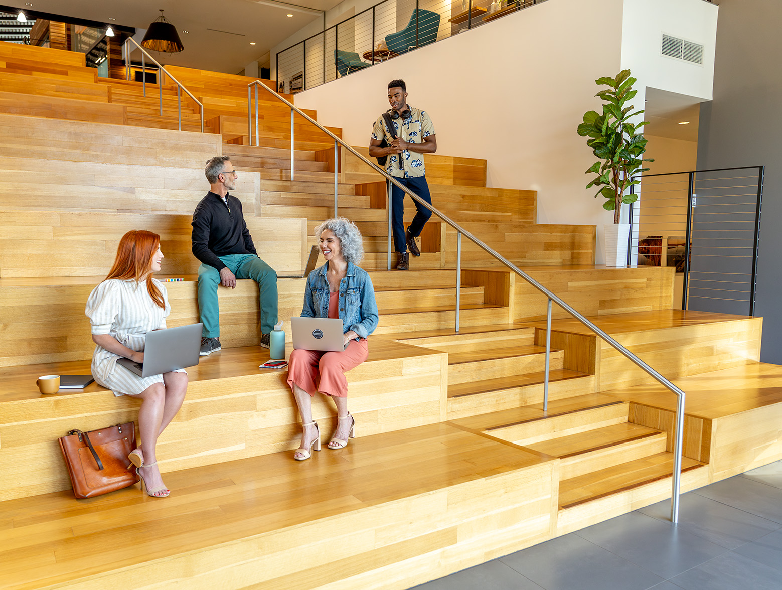 People working and talking in office stairs setting