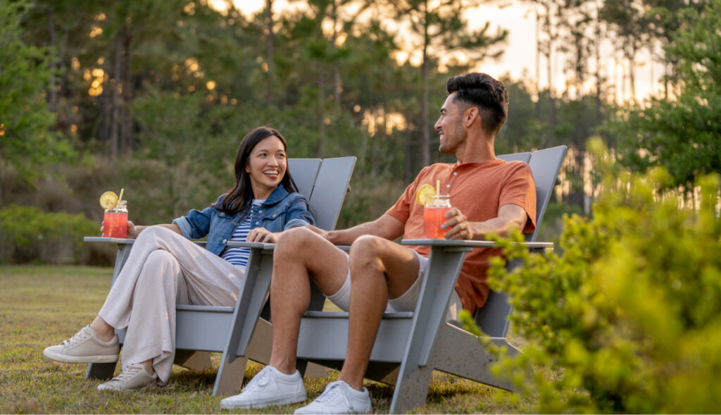 Couple sitting in adirondak chairs with lemonade