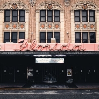 Facade of the Florida Theatre featuring a large, pink neon "Florida" sign, ornate brickwork, and blacked-out windows above the entrance—capturing the unique charm found near new homes in Wildlight FL.