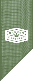 A green textured banner with a white hexagon logo that reads "Garden District," featuring three leaf icons above the text, represents the Wildlight Yulee Florida community.