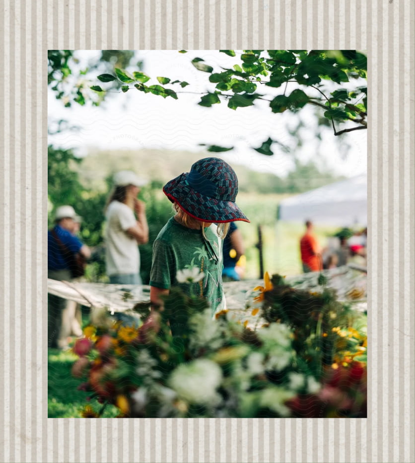 Woman looking at flowers in a sunhat