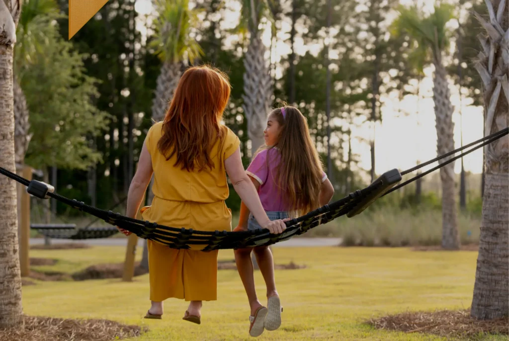 Mother and daughter on hammock talking