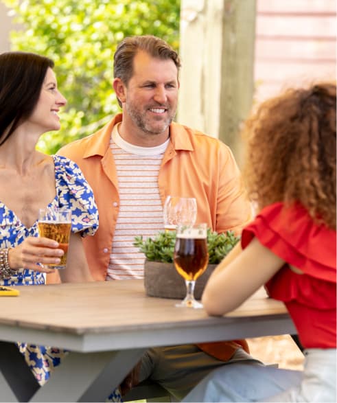 Group of friends sitting at a table outdoors