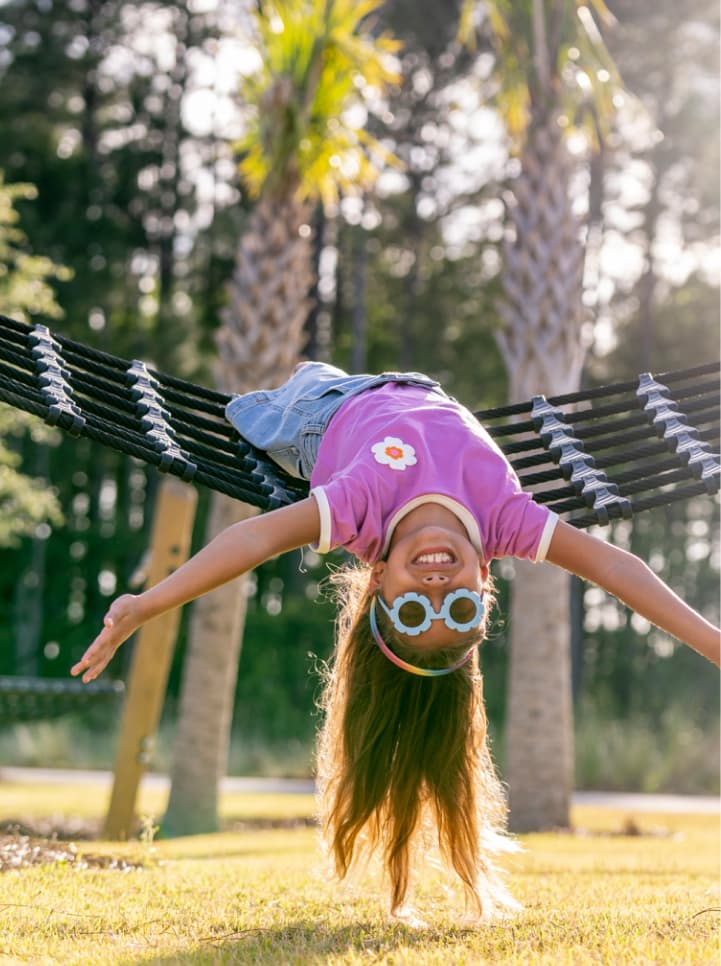 Young girl playing on a hammock