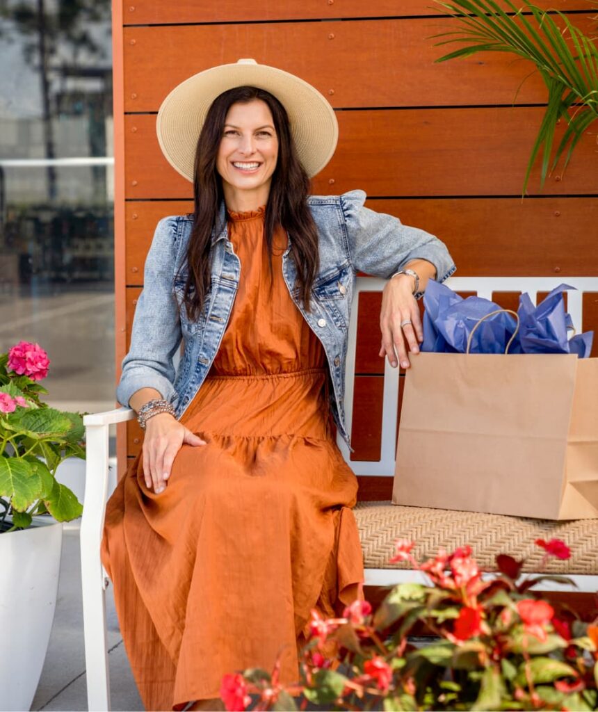 Woman sitting on porch wearing sunhat