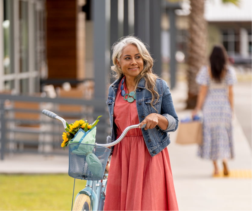 Young woman walking her bicycle