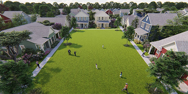 Aerial view of a grassy communal area surrounded by homes in Nassau County Florida, with several people walking, standing, and playing on the lawn.