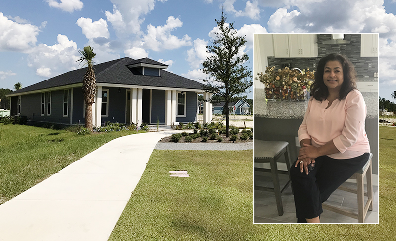 A single-story house with a front porch and landscaped yard in the Wildlight Yulee Florida community; an inset shows a woman sitting indoors on a stool, smiling at the camera.