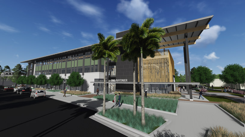 Modern three-story building with large glass windows, palm trees, and landscaped pathways, viewed from the street under a partly cloudy sky—perfect for those seeking new homes in Wildlight FL.