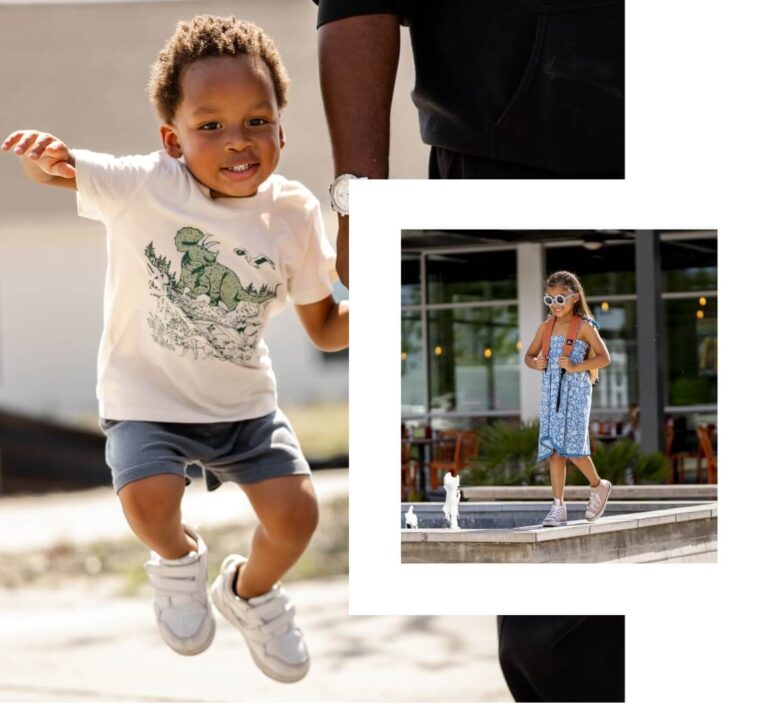 A young boy in a dinosaur shirt jumps in the air while a girl in a blue dress and sunglasses stands near a fountain, capturing the playful spirit of the Wildlight Yulee Florida community.