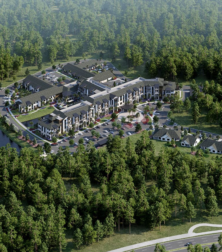 Aerial view of a modern residential complex surrounded by dense forest, with multiple buildings, parking lots, and a main road visible in the foreground.